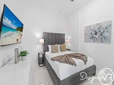 a bedroom with a bed and a painting on the wall at Villa wpool spa game room in Hollywood