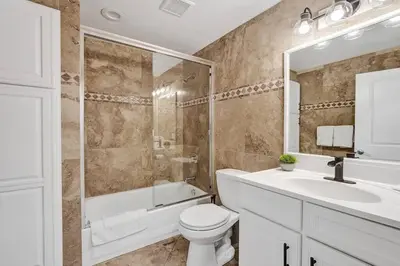 a bathroom with a toilet and a shower and a sink at Hot Tub! Roof Top! Firepit! Boat Dock! in Fort Lauderdale