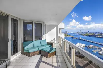 a balcony with a chair and a view of the water at The Grand Wonder in Miami
