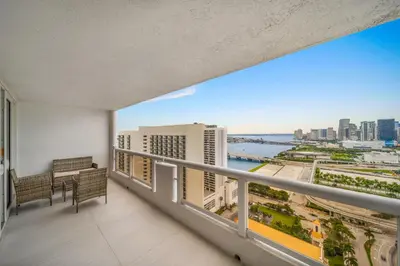 a balcony with a view of the city and the ocean at The Grand Wonder in Miami