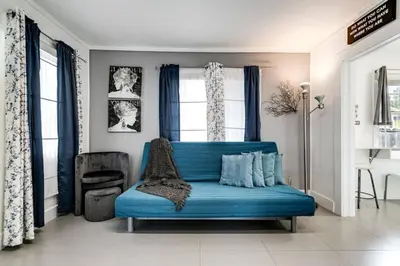 a blue couch in a living room with a window at Welcoming 2-BR apartment - 6 people V1 in Miami