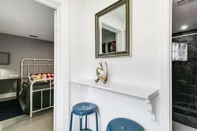 a bathroom with a mirror and two blue stools at Welcoming 2-BR apartment - 6 people V1 in Miami