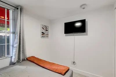 a room with a tv on a white wall at Captivating 2-BR apartment for 5 people V3 in Miami