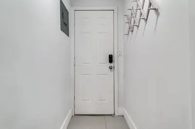 a hallway with a white door and a white wall at Miami studio apartment, Very centric, Fast Wi-Fi V4 in Miami
