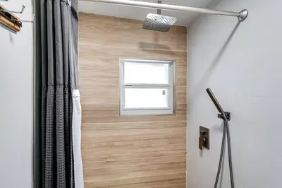 a bathroom with a shower curtain and a window at Miami studio apartment, Very centric, Fast Wi-Fi V4 in Miami