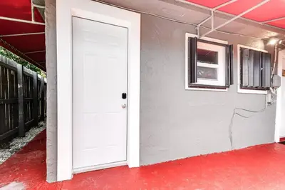 a white door on the side of a building at Wonderful Studio Cottage 2 people V5 in Miami
