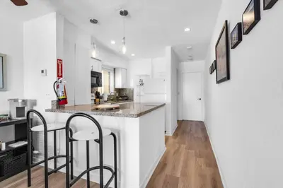 a kitchen with a counter and two bar stools at Beach Front 1 Bedroom with Ocean View, Pool and Parking in Hollywood