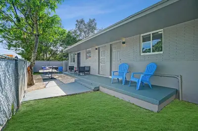a house with two blue chairs on a patio at Wynwood Bungalow Hottub & Pking in Miami