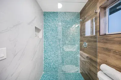 a bathroom with a shower with a glass door at 4 Bedroom Holiday Retreat BBQ Marketplace in Miami