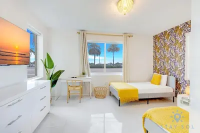 a living room with a bed and a window at Hollywood Broadwalk Haven - Free Parking in Hollywood