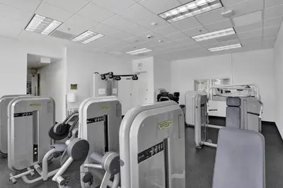 a gym with a row of exercising machines in a room at Superb Private unit Perfectly Located In Brickell in Miami