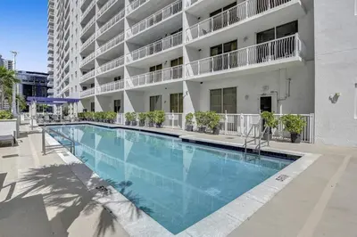 a large swimming pool in front of a building at Superb Private unit Perfectly Located In Brickell in Miami