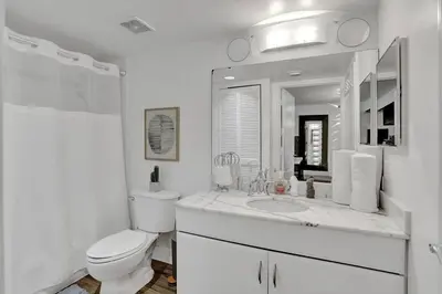 a white bathroom with a toilet and a sink at Superb Private unit Perfectly Located In Brickell in Miami