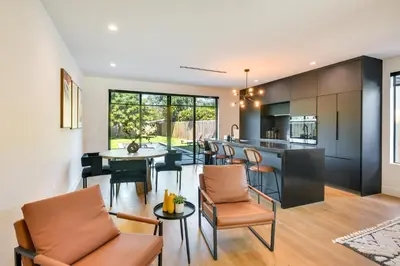an open kitchen and living room with a bar and chairs at Modern Miami Home with Pool 1 Mi to Design District! in Miami