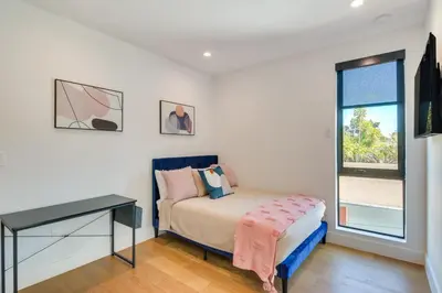 a bedroom with a bed and a desk and a window at Modern Miami Home with Pool 1 Mi to Design District! in Miami