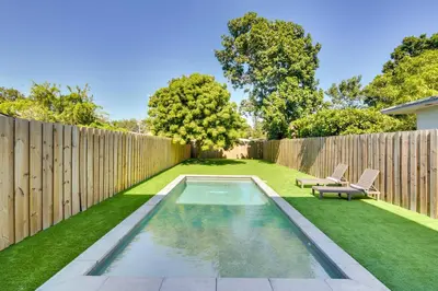 a backyard with a swimming pool and a fence at Modern Miami Home with Pool 1 Mi to Design District! in Miami