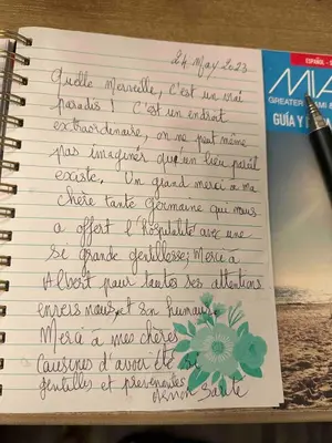 a handwritten letter in a notebook with a pen at Magical Beachfront King Escape in Hollywood