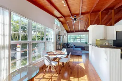 a kitchen and living room with a table and chairs at Hallandale Hideaway in Hallandale Beach