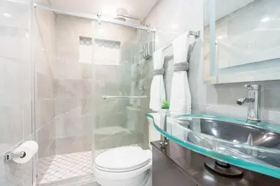 a bathroom with a toilet and a sink at New Miami & Calle Ocho Home with Arcade! in Miami