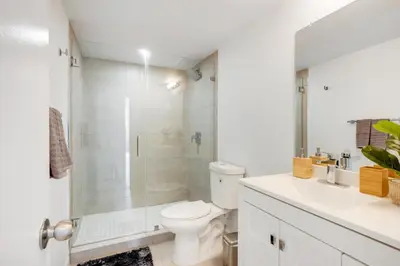 a bathroom with a shower and a toilet and a sink at Spacious Family Escape with Pool & Beach Access in Sunny Isles Beach