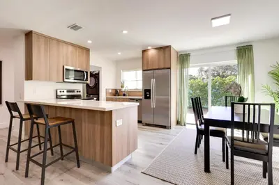 a kitchen with a table and chairs and a dining room at Spacious and Serene Miami Home Walk to Metrorail! in Miami