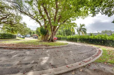 a winding road with a tree in the middle at Spacious and Serene Miami Home Walk to Metrorail! in Miami