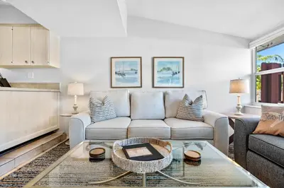 a living room with a couch and a table at Citrus Isles Waterfront Home in Fort Lauderdale