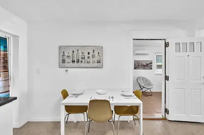 a white dining room with a white table and chairs at 3 Bedroom Villa In F Lauderdale Casino & Beach in Fort Lauderdale