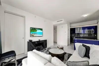a living room with a white couch and a table at WVR Vacation Residences 709 in Fort Lauderdale