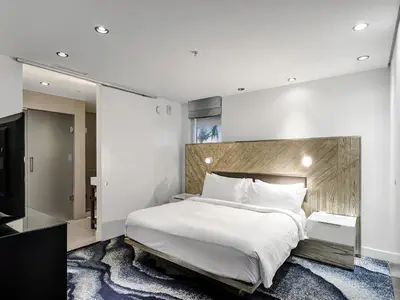 a bedroom with a large bed and a television at WVR Vacation Residences 602 in Fort Lauderdale