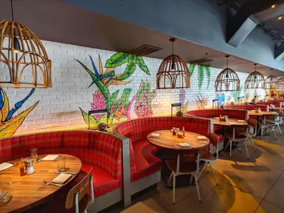 a restaurant with red booths and a colorful wall at WVR Vacation Residences 602 in Fort Lauderdale