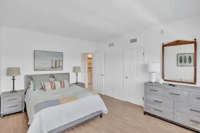 a bedroom with a bed and a dresser and a mirror at Fort Lauderdale Yacht & Beach Club 412 in Fort Lauderdale