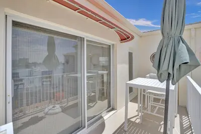 a balcony with a table and a large window at Fort Lauderdale Yacht & Beach Club 412 in Fort Lauderdale