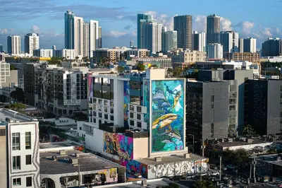 a city with a large mural on the side of a building at Moxy Miami Wynwood in Miami