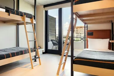 a bedroom with bunk beds and a balcony at Moxy Miami Wynwood in Miami