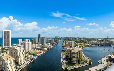 an aerial view of a city with a river and buildings at Ocean Views - Pool & Gym - Pet Friendly - Close to Beach in Hallandale Beach