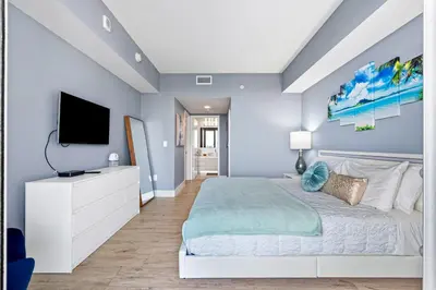 a bedroom with a bed and a tv at Ocean Views - Pool & Gym - Pet Friendly - Close to Beach in Hallandale Beach