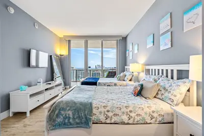 two beds in a bedroom with a window at Ocean Views - Pool & Gym - Pet Friendly - Close to Beach in Hallandale Beach