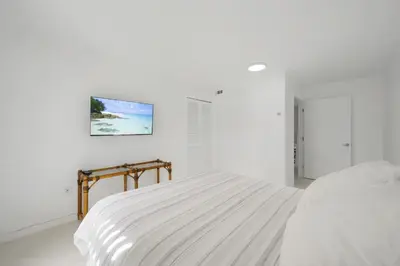 a white bedroom with a bed and a picture on the wall at Le Cartier Sunny Isles Ocean Paradise in Sunny Isles Beach