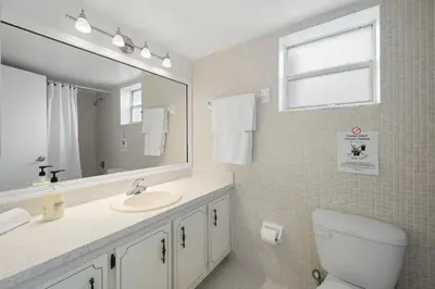 a bathroom with a sink and a mirror and a toilet at Le Cartier Sunny Isles Ocean Paradise in Sunny Isles Beach