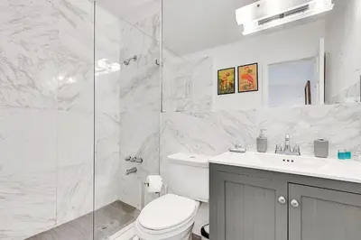 a white bathroom with a toilet and a shower at Casa Linda Gated 3 bed 2 bath by the River 1810 in Miami