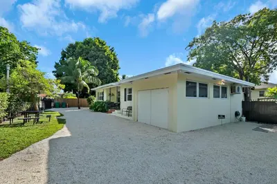 a small white house with a driveway at Casa Linda Gated 3 bed 2 bath by the River 1810 in Miami