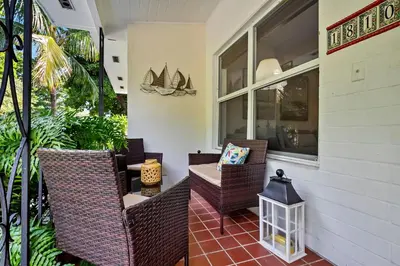 a patio with wicker chairs and a table on a porch at Casa Linda Gated 3 bed 2 bath by the River 1810 in Miami