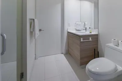 a white bathroom with a toilet and a sink at Unwind in Your Amazing City View Apartment in Miami