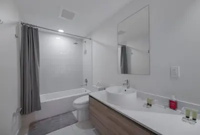 a white bathroom with a sink and a toilet at Unwind in Your Amazing City View Apartment in Miami