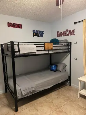two bunk beds in a room with a wall with the words game remorse at Beds & Sheets DOWNTOWN in Miami