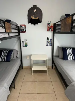 a room with two bunk beds and a table at Beds & Sheets DOWNTOWN in Miami