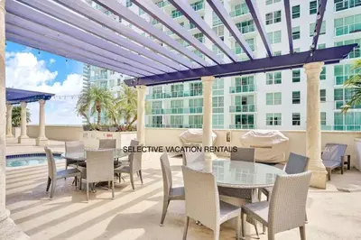 a patio with a table and chairs and a building at Miami Brickell 3 Bedrooms high ceiling loft in Miami