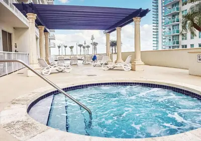 a swimming pool on a balcony with chairs and a building at Miami Brickell 3 Bedrooms high ceiling loft in Miami