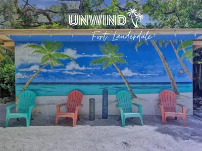 a mural of four chairs on the beach at Tropical Oasis - BBQ and Beach-Inspired Nook in Fort Lauderdale